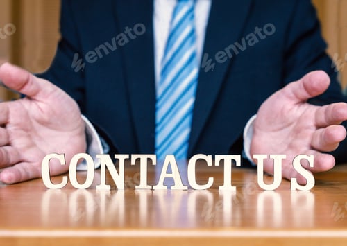 Preview: CONTACT US letters between hands and desk