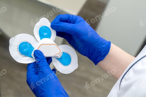 Preview: Hands holding a medical device with gel pads