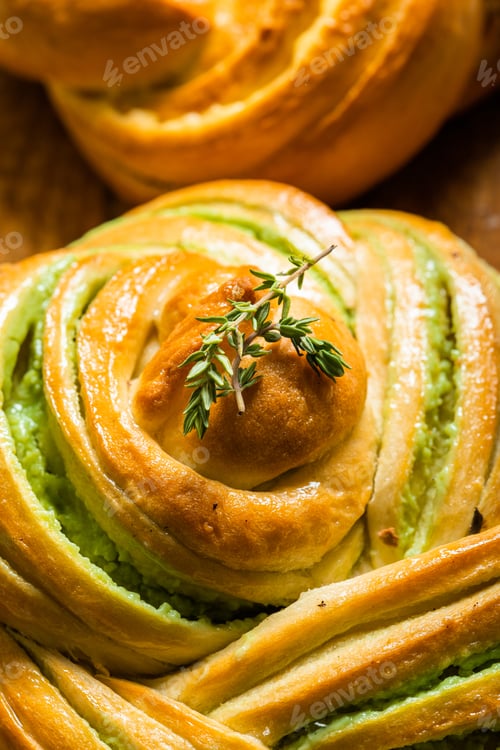 Preview: homemade buns with cream and pistachio cream decorated with thyme freshly baked for breakfast