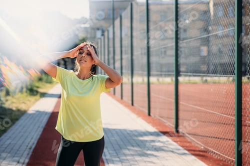 Preview: Attractive fitness lady feeling tired after morning run