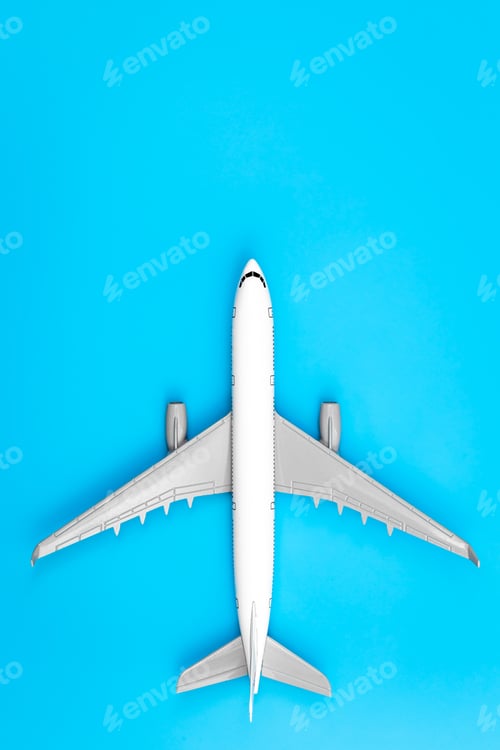 Preview: White plane, airplane on a blue background, flat lay, close up.