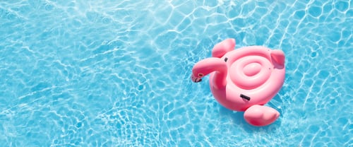 Preview: Pink flamingo inflatable ring in sunny pool