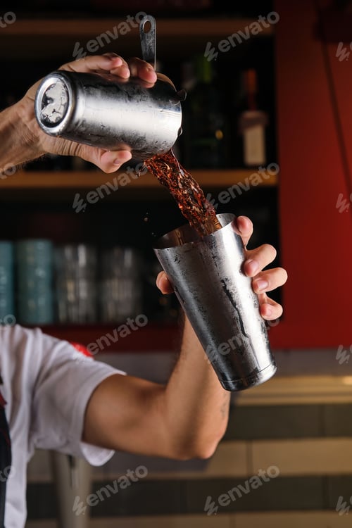 Preview: Unrecognizable barman mixing drink in pub