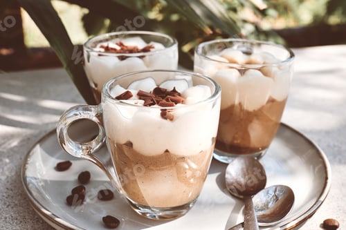 Preview: Traditional Italian dessert Tiramisu in glass cups on gray table.