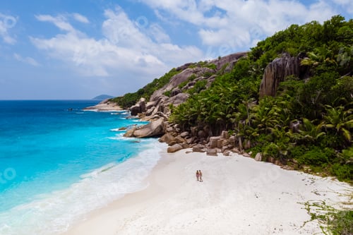 Preview: men and woman walking at a tropical beach, Drone view from above Seychelles Cocos Island