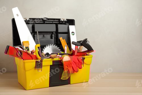 Preview: Box with different carpenter's tools on wooden table. Space for text