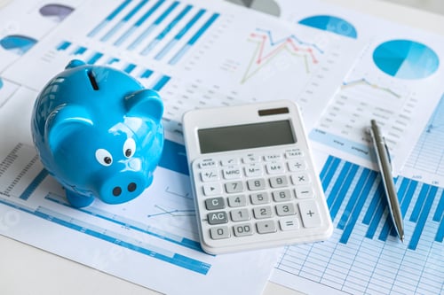 Preview: Bright Piggy Bank and Financial Charts on Desk