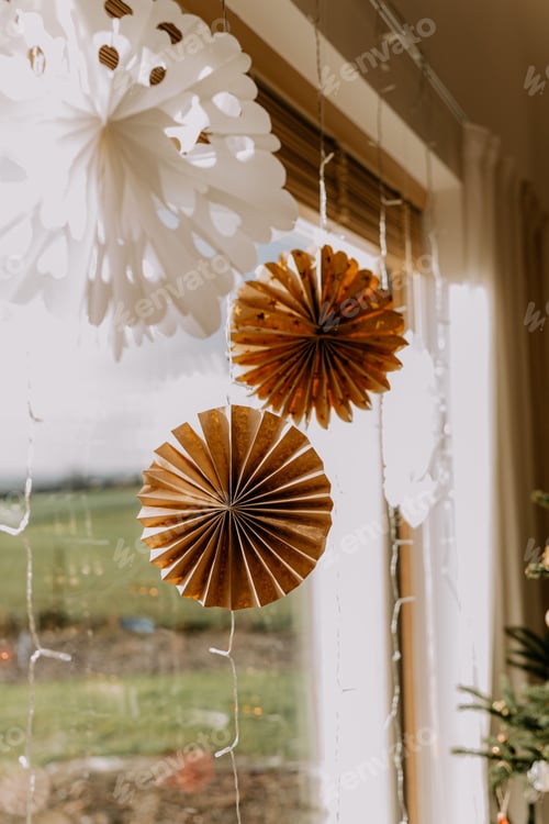 Preview: a window with decorations hanging on it near a christmas tree