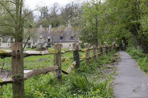 Idyllic Countryside Scene with Mossy Fence and Path