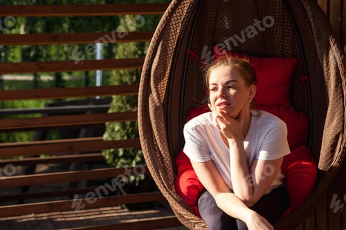 Preview: Contemplative Moments in a Cozy Outdoor Setting With a Stylish Hanging Chair