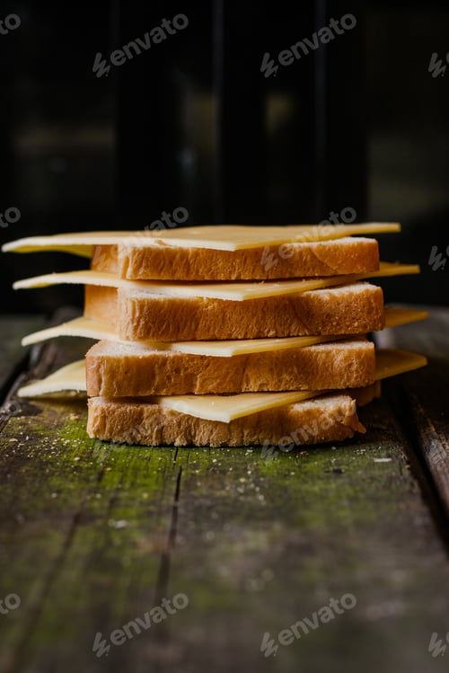 Preview: Slices Of Cheese And Bread On Wooden Background