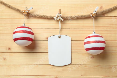Preview: clothespin hanging with blank paper on wooden background