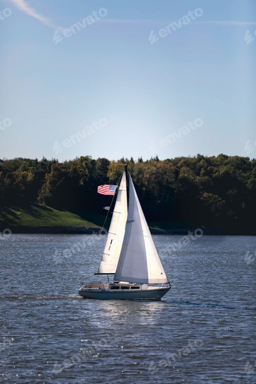 Preview: Sailing boat with American flag on the sea