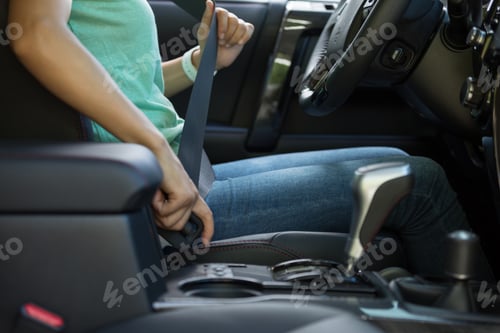 Preview: Woman driver buckle up the seat belt before driving car