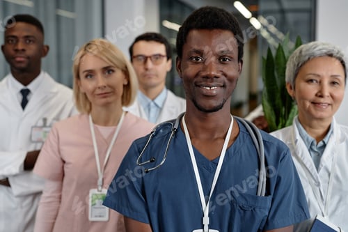 Preview: Young smiling African American male assistant in blue uniform