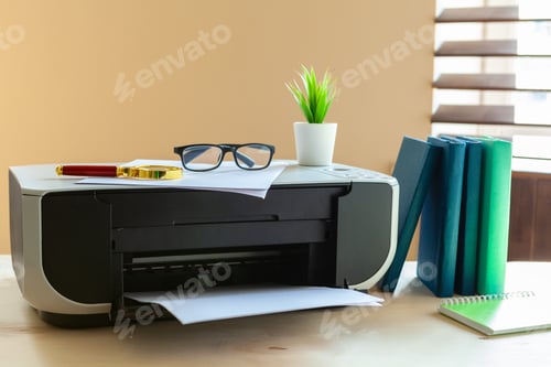 Preview: Close up of an office table with printer on it