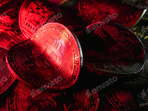 Preview: Twisted coins with bitcoin symbol on red light. Concept of a cryptocurrency market crisis.