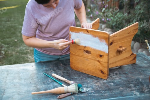 Preview: Painting a wooden furniture outdoors, an eco-friendly re-use business.