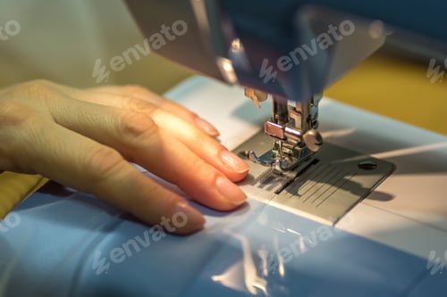 Preview: close up mechanism of sewing machine foot with needle and thread