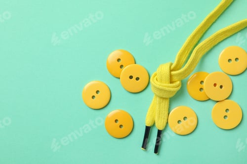 Preview: Yellow buttons and shoelaces on mint background