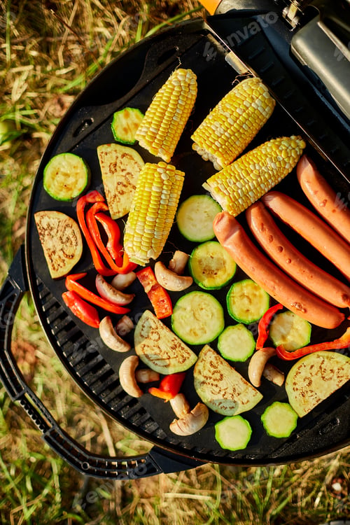 Preview: Roasting vegetables and vegan sausages on the barbecue gas grill outdoor in the backyard