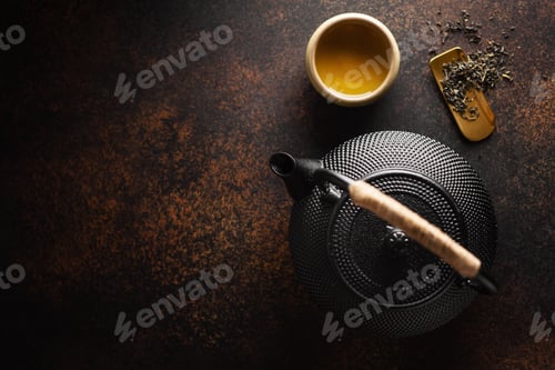 Preview: Teapot with tea on dark background
