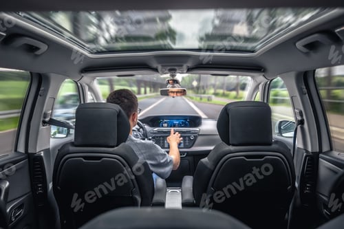 Preview: Driver using touch screen in car. Digital road trip.
