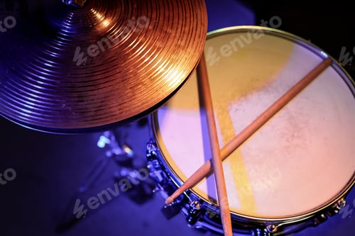 Preview: Drum sticks on a snare drum close up top view.