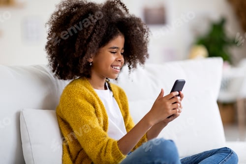 Preview: Cute black girl enjoying newest mobile app
