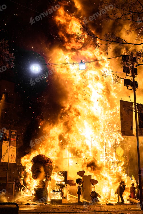 Preview: Valencia, Spain - March 19, 2019: Detail of a Falla Valenciana burning between flames of fire.
