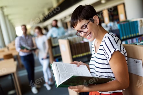 Preview: Happy group of success students studying and working together in a college library
