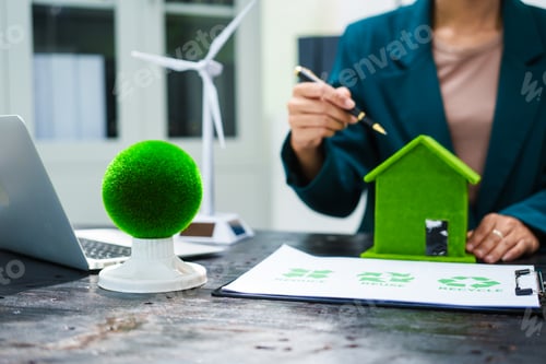 Preview: An Asian businesswoman sits at her desk, discussing clean energy solutions their impact on homes