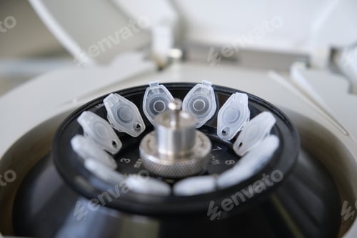 Preview: Close up of small tubes eppendorfs on a mini centrifuge in a laboratory. Minispin full of tubes.