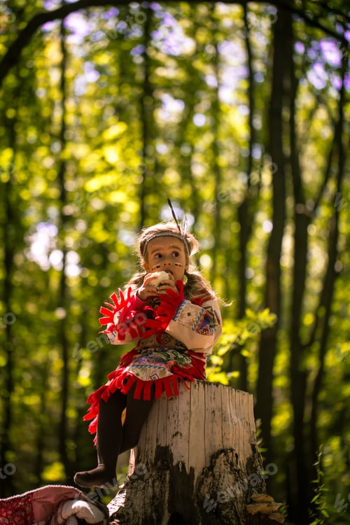 Preview: beautiful little girl playing on the nature of the Indians