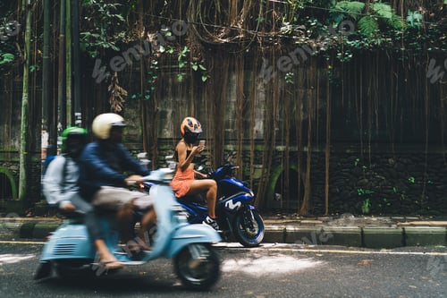Preview: Unrecognizable female biker surfing smartphone