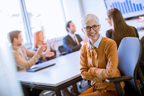 Preview: Portrait of cheerful senior businesswoman in office
