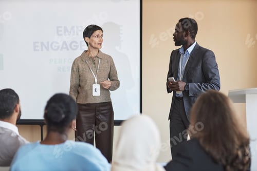 Preview: Confident mature female coach and her young male assistant