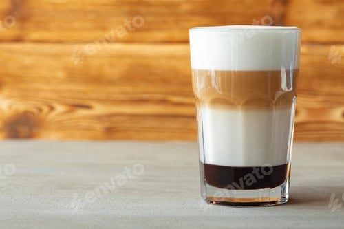 Preview: Glass of tasty aromatic latte on wooden background