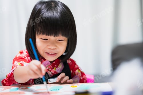 Preview: Happy Asian child painting water color on paper art. Sweet smile girl with lesson in class.