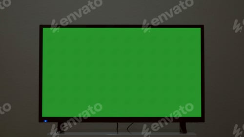 Preview: Plasma TV with green screen stands on background wall. Concept. Green-screen TV stands on background