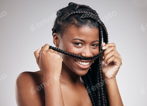 Preview: Cropped portrait of an attractive young woman posing in studio against a brown background