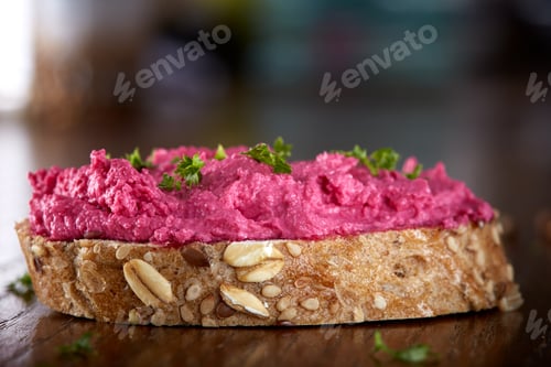Preview: Spread made from red beet and cheese cream on a slice of bread