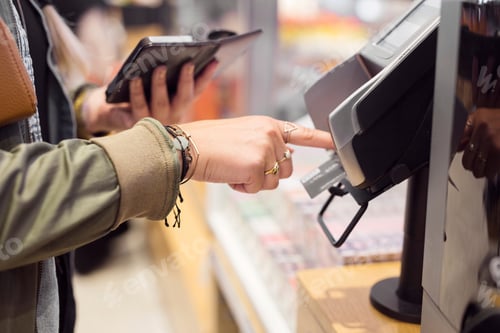 Preview: Customer making a contactless payment at a checkout counter.