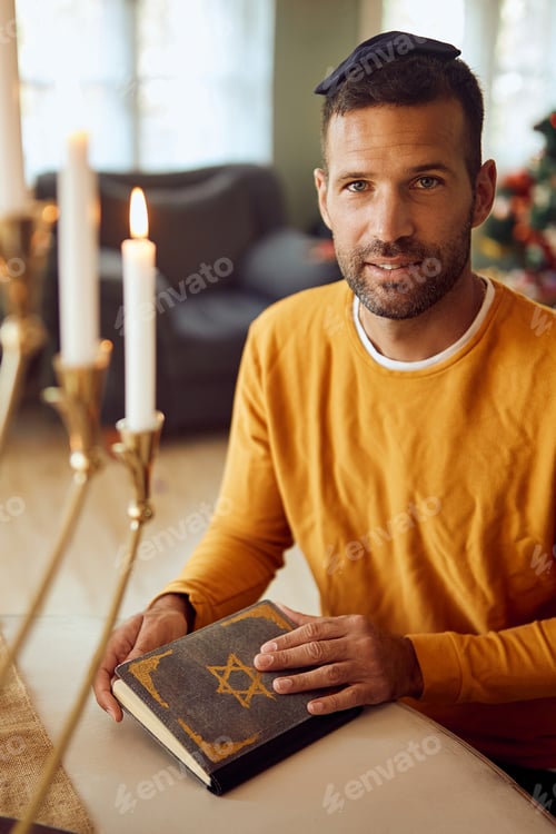 Preview: Portrait of Jewish man with Hebrew bible on Hanukkah at home.