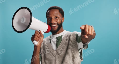 Preview: Portrait of black man, megaphone or smile for pointing to news announcement on blue background. You