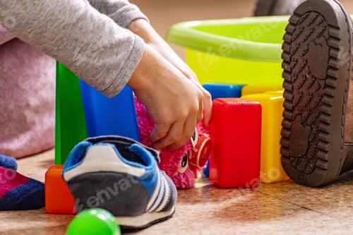 Preview: Children's hands and multi-colored plastic objects