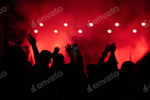 Preview: Abstract photo of crowd at concert and blurred stage lights.