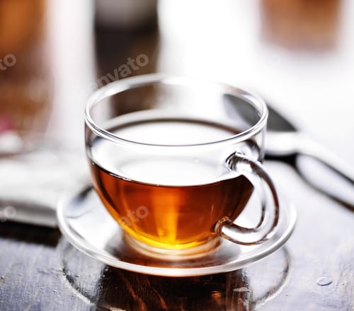 Preview: glass of tea with teabag in the background