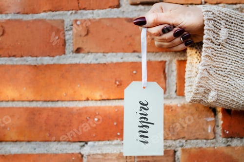 Preview: Woman holding a white tag