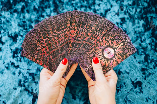 Preview: a young woman holds tarot cards and guesses on the cards
